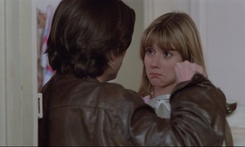 Movie still from “Love on the Run” (1979), directed by François Truffaut – A woman looking in the reflection of herself in a mirror; Close Up shot, Over the shoulder angle