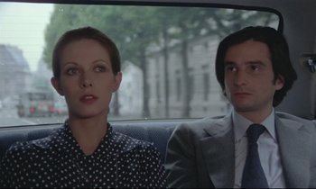 Movie still from “Love on the Run” (1979), directed by François Truffaut – A man and a woman sitting in the back of a car; Close Up shot, Low angle