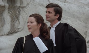 Movie still from “Love on the Run” (1979), directed by François Truffaut – A man and a woman in black and white robes; Medium shot, Low angle
