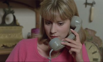 Movie still from “Love on the Run” (1979), directed by François Truffaut – A woman holding a phone up to her ear; Close Up shot, High angle