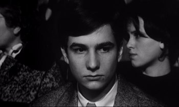 Movie still from “Love on the Run” (1979), directed by François Truffaut – A man and a woman are looking at the camera; Close Up shot, High angle