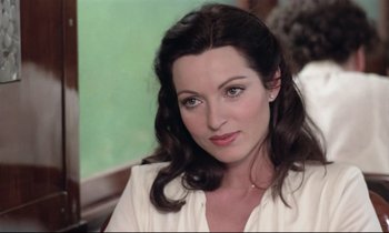 Movie still from “Love on the Run” (1979), directed by François Truffaut – A person wearing a white shirt; Close Up shot, Over the shoulder angle