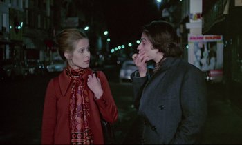 Movie still from “Love on the Run” (1979), directed by François Truffaut – A woman and a man standing next to each other on the street; Medium shot, Over the shoulder angle