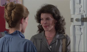 Movie still from “Love on the Run” (1979), directed by François Truffaut – Two women talking to each other in front of a wall; Close Up shot, Over the shoulder angle