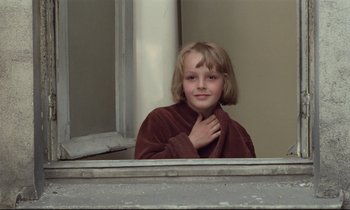 Movie still from “Love on the Run” (1979), directed by François Truffaut – A young girl is standing in front of a mirror; Close Up shot, Low angle