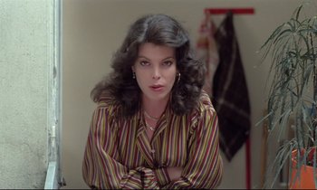 Movie still from “Love on the Run” (1979), directed by François Truffaut – A woman in a striped shirt sitting in front of a mirror; Close Up shot, Over the shoulder angle