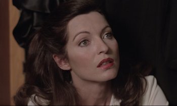 Movie still from “Love on the Run” (1979), directed by François Truffaut – A person with long brown hair; Close Up shot, High angle