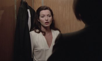 Movie still from “Love on the Run” (1979), directed by François Truffaut – A woman in a white blouse is looking at a man in a suit; Medium shot, Over the shoulder angle