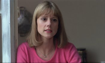 Movie still from “Love on the Run” (1979), directed by François Truffaut – A person wearing a pink shirt; Close Up shot, Low angle