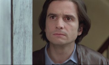 Movie still from “Love on the Run” (1979), directed by François Truffaut – A person with long brown hair; Close Up shot, Low angle
