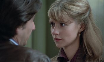 Movie still from “Love on the Run” (1979), directed by François Truffaut – A young woman with blonde hair is looking at a young man; Close Up shot, Over the shoulder angle