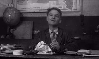 Movie still from “Love on the Run” (1979), directed by François Truffaut – A man sitting at a table with food in front of him; Close Up shot, Low angle
