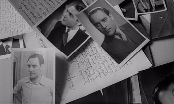 Movie still from “Love on the Run” (1979), directed by François Truffaut – A bunch of old photographs of a man; Close Up shot, High angle