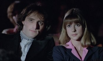 Movie still from “Love on the Run” (1979), directed by François Truffaut – A man and a woman sitting next to each other; Close Up shot, Low angle