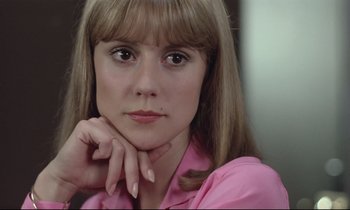 Movie still from “Love on the Run” (1979), directed by François Truffaut – A person wearing a pink shirt; Close Up shot, Low angle