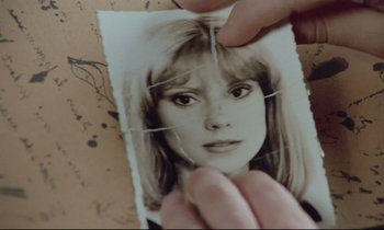 Movie still from “Love on the Run” (1979), directed by François Truffaut – A person holding a picture of a woman with long blonde hair; Extreme Close Up shot, Overhead angle