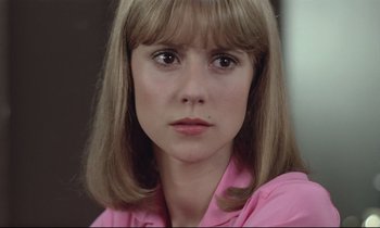 Movie still from “Love on the Run” (1979), directed by François Truffaut – A person wearing a pink shirt; Close Up shot, Over the shoulder angle