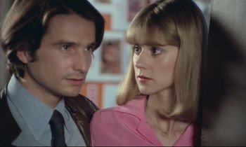 Movie still from “Love on the Run” (1979), directed by François Truffaut – A man and a woman standing next to each other; Close Up shot, High angle