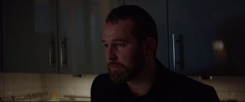 Movie still from “Loveless” (2017), directed by Andrey Zvyagintsev – A man with a goatee and a beard looking to his left; Close Up shot, Over the shoulder angle