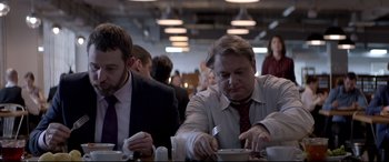 Movie still from “Loveless” (2017), directed by Andrey Zvyagintsev – A man in a suit and tie eating a bowl of soup; Medium shot, Over the shoulder angle