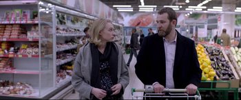 Movie still from “Loveless” (2017), directed by Andrey Zvyagintsev – A man and a woman are standing in a grocery store; Medium shot, Over the shoulder angle