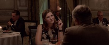 Movie still from “Loveless” (2017), directed by Andrey Zvyagintsev – A woman sitting at a table with a cigarette in her mouth; Medium shot, Over the shoulder angle