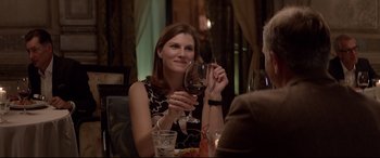 Movie still from “Loveless” (2017), directed by Andrey Zvyagintsev – A woman sitting at a table holding up a glass of wine; Close Up shot, Over the shoulder angle
