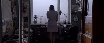 Movie still from “Loveless” (2017), directed by Andrey Zvyagintsev – A woman standing in front of a large window; Wide shot, Low angle