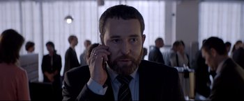 Movie still from “Loveless” (2017), directed by Andrey Zvyagintsev – A man with a beard talking on a cell phone; Close Up shot, Over the shoulder angle