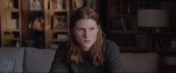 Movie still from “Loveless” (2017), directed by Andrey Zvyagintsev – A person sitting in a room; Close Up shot, Over the shoulder angle