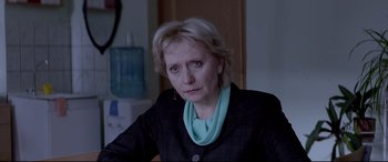 Movie still from “Loveless” (2017), directed by Andrey Zvyagintsev – A person sitting in a room; Close Up shot, Over the shoulder angle