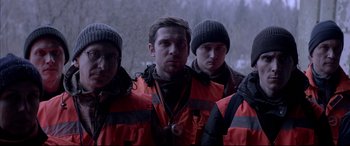 Movie still from “Loveless” (2017), directed by Andrey Zvyagintsev – A group of men standing next to each other in winter clothing; Medium shot, Low angle