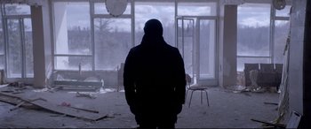 Movie still from “Loveless” (2017), directed by Andrey Zvyagintsev – A person standing in front of an open window; Wide shot, Low angle