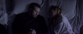 Movie still from “Loveless” (2017), directed by Andrey Zvyagintsev – A man and a woman laying in bed together; Medium shot, Overhead angle