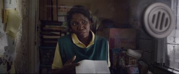 A woman holding a piece of paper in her hand