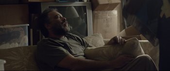 A man laying on a couch in a living room