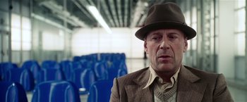 Movie still from “Lucky Number Slevin” (2006), directed by Paul McGuigan – A man wearing a hat and a suit; Close Up shot, Over the shoulder angle