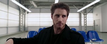 Movie still from “Lucky Number Slevin” (2006), directed by Paul McGuigan – A person wearing a black jacket; Close Up shot, Over the shoulder angle