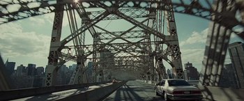 Movie still from “Lucky Number Slevin” (2006), directed by Paul McGuigan – A view of a bridge from a car on the road; Extreme Wide shot, High angle