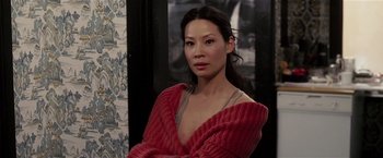 Movie still from “Lucky Number Slevin” (2006), directed by Paul McGuigan – A woman in a red sweater posing for a picture; Close Up shot, High angle