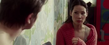 Movie still from “Lucky Number Slevin” (2006), directed by Paul McGuigan – A woman wearing a red sweater looking in a mirror; Close Up shot, Over the shoulder angle