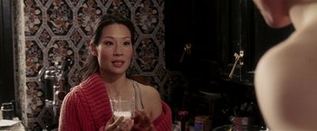 Movie still from “Lucky Number Slevin” (2006), directed by Paul McGuigan – A woman holding a glass of milk in her hand; Close Up shot, High angle