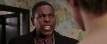 Movie still from “Lucky Number Slevin” (2006), directed by Paul McGuigan – A person wearing a suit and tie; Close Up shot, Over the shoulder angle