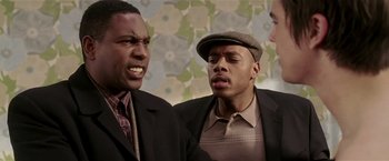 Movie still from “Lucky Number Slevin” (2006), directed by Paul McGuigan – A group of men standing next to each other in a room; Close Up shot, Over the shoulder angle