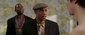 Movie still from “Lucky Number Slevin” (2006), directed by Paul McGuigan – A man wearing a hat and a suit; Close Up shot, Low angle