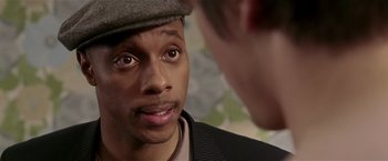 Movie still from “Lucky Number Slevin” (2006), directed by Paul McGuigan – A person wearing a hat; Close Up shot, Over the shoulder angle