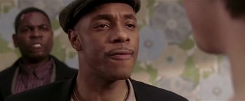 Movie still from “Lucky Number Slevin” (2006), directed by Paul McGuigan – A person wearing a hat and a jacket; Close Up shot, Low angle