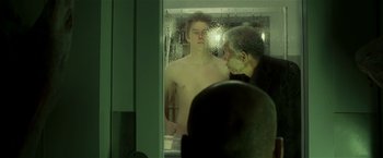 Movie still from “Lucky Number Slevin” (2006), directed by Paul McGuigan – A man in the shower looking in the mirror; Medium shot, Over the shoulder angle