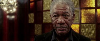 Movie still from “Lucky Number Slevin” (2006), directed by Paul McGuigan – An older man in a black jacket and a black shirt; Close Up shot, Low angle