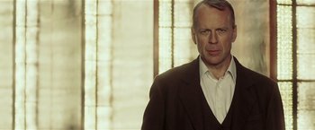 Movie still from “Lucky Number Slevin” (2006), directed by Paul McGuigan – A man in a suit and white dress shirt; Close Up shot, Low angle